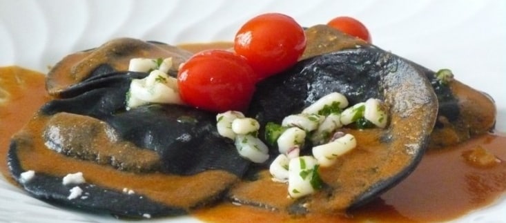 Ravioli neri di ricotta con ragù di calamari, pomodorini e bisque di gamberi ricetta