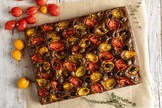 Focaccia nera con pomodorini del Piennolo e olive